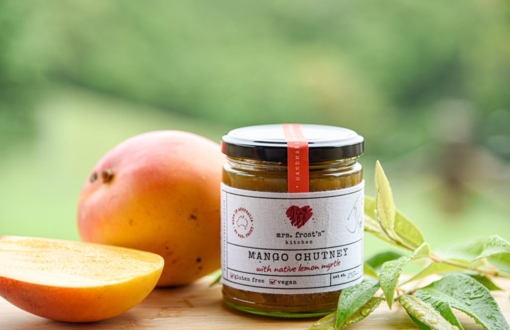 A jar of Mango chutney showing key ingredients of mango and lemon myrtle leaves